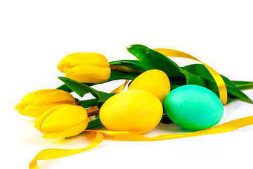Easter eggs with yellow tulips flowers on a white background