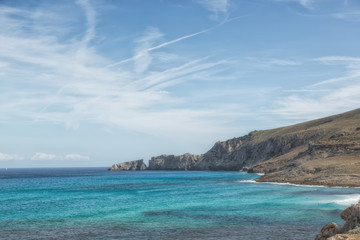 Küste Cala Mesquida, Mallorca mit blauem Himmel und Wolken