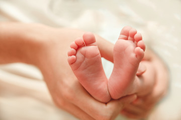 Obraz na płótnie Canvas The Small Cute Soles of Newborn Feets are in the Father's Hands.Family and love concept.