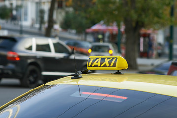 Yellow cab with taxi sign on roof