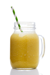 Smoothies of pineapple, banana and orange in a glass jar