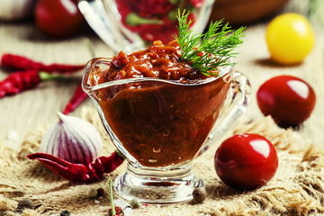Spicy tomato sauce with pepper and garlic in a glass bowl on the