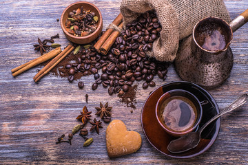 Coffee cup coffee beans and biscuits, cookies in the shape of heart on wooden background