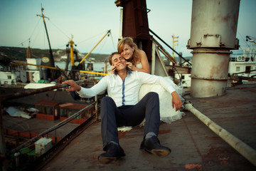 Fototapeta na wymiar Wedding bride and groom on deck of boat, stylish couple.