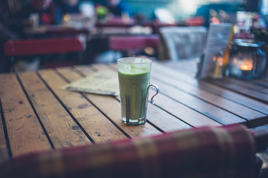 Green smoothie on table outside