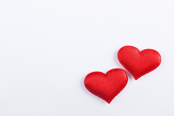 two red hearts on a white background