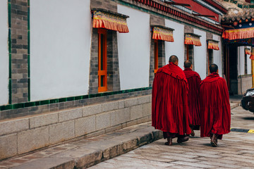 QINGHAI, CHINA - October 4, 2016: Tibetan monks in the ancient temple building architecture of Kumbum monastery in Qinghai Province, China