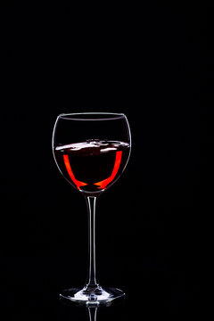 Wine glasses with wine bottle on a black background, minimalism,