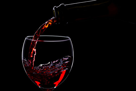 Wine glasses with wine bottle on a black background, minimalism,