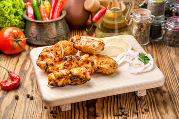 Assorted delicious grilled meat with vegetable on white plate  picnic table for family bbq party