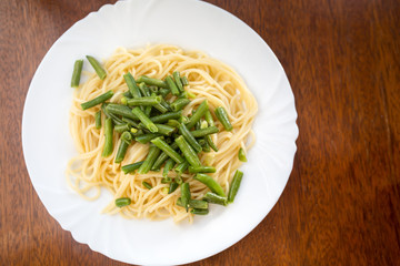 Green beans and spaghetti on a plate. Healthy food