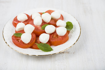 Caprese salad on a wooden table.