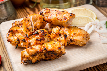 Assorted delicious grilled meat with vegetable on white plate  picnic table for family bbq party