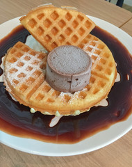 Waffle topped with chocolate and Ice cream chocolate.