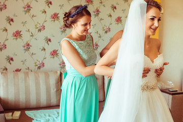 The bridesmaids helping for bride