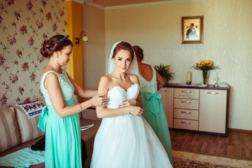 The bridesmaids helping for bride