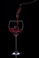Wine glasses with wine bottle on a black background, minimalism,