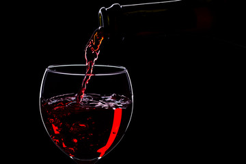 Wine glasses with wine bottle on a black background, minimalism,
