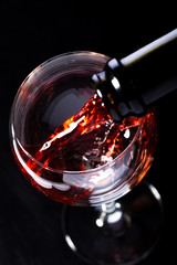 Wine glasses with wine bottle on a black background, minimalism,