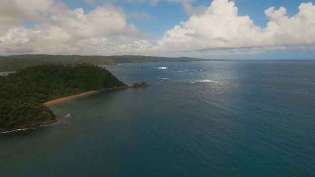 Aerial view: beach, tropical island, bay and lagoon. Tropical landscape sky, clouds and mountains rocks with rainforest. Aerial: Blue lagoon in the ocean. Aerial video.Seascape. 4K video. Travel