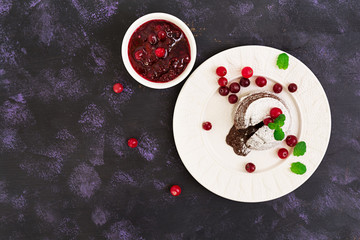 Chocolate fondant with cranberry sauce. Top view.