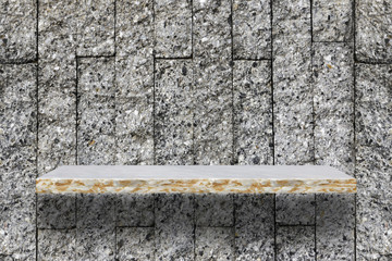 Empty marble shelf on wall