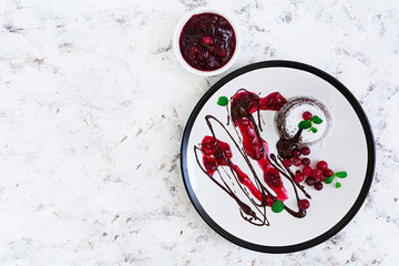 Chocolate fondant with cranberry sauce. Top view
