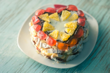 Homemade cake on a platter on a wooden board