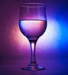 A glass of water on a cool background,