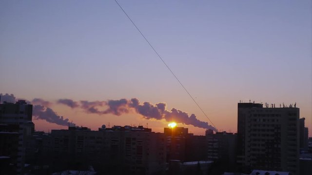 beautiful sunset on a background of cityscape with smoking chimneys, Timelapse 4k