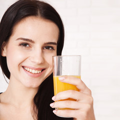 Closeup photo of sexy young woman drinking orange juice