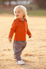 Fototapeta premium blonde caucasian boy smiles outdoor at park