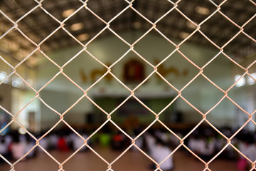 Fototapeta premium cage metal net and blur photo of student sit in auditorium