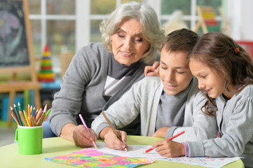 Grandmother with kids drawing