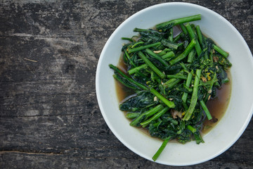 stir fried morning glory. phad puk boong fri dang. thai food on wooden background