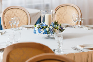 white table blue flowers candle decoration