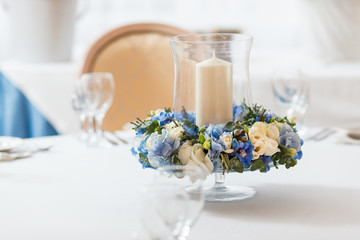 white table blue flowers candle decoration