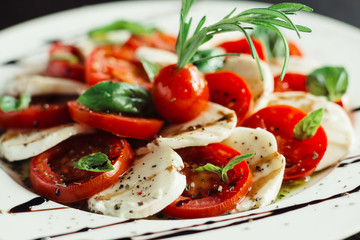 Appetizer with feta and tomatoes on dish