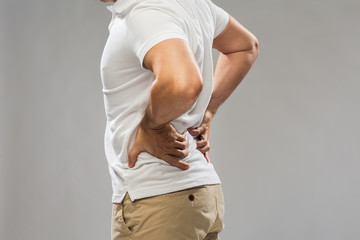 Obraz na płótnie Canvas close up of man suffering from backache