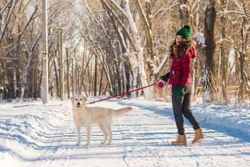 Portrait of a young woman with  dog on  winter walk. 