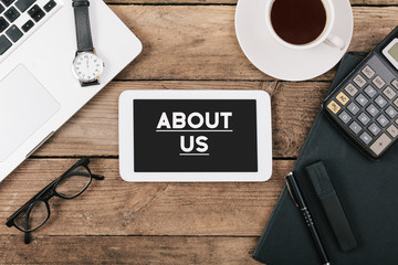 About us text on tablet computer on office desk