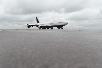low angle view of big airliner passenger jet plane on taxiway or runway