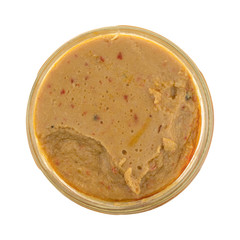 Hummus dip in an opened jar isolated on a white background.