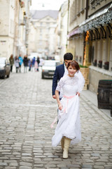 Bride and groom hugging each other gently during a walk