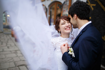 portrait of smiling bride and groom in wedding day