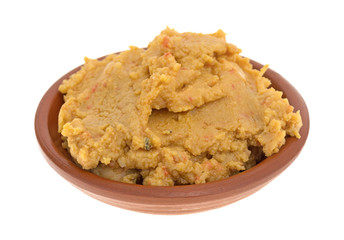 Hummus dip in a bowl isolated on a white background.