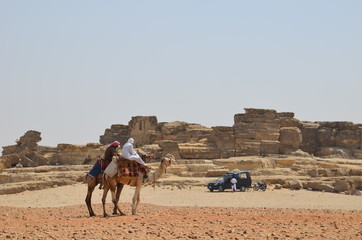 Pyramid in sand dust under gray clouds