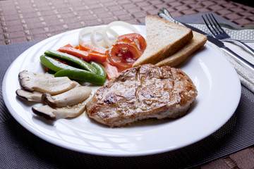 Chicken steak in white dish with mushroom , bread , green bean , tomato and onion