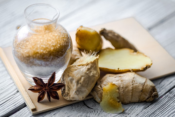 still life of fresh ginger with a wooden spoon  sugar