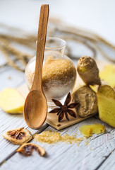 still life of fresh ginger with a wooden spoon  sugar